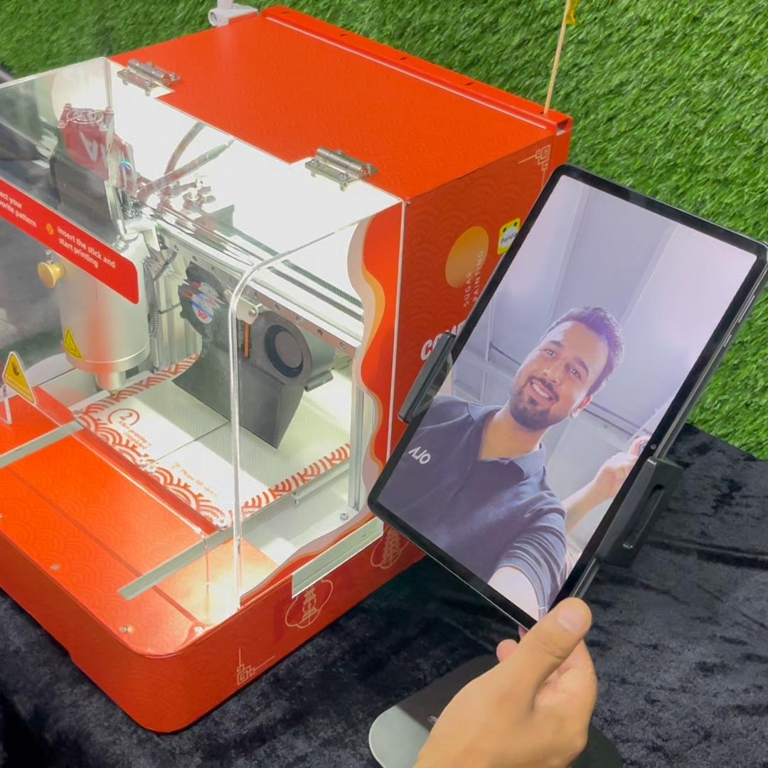 Guests using the AI Sugar Painting Robot in UAE, watching it create edible art and enjoying unique designs at events, kids activities, and parties.